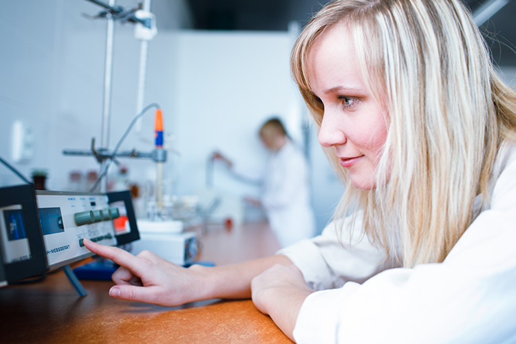 Closeup of a female researcher/chemistry student carrying out experiments in a lab